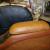 Custom center armrest recovered with brown ostrich and matching vinyl 